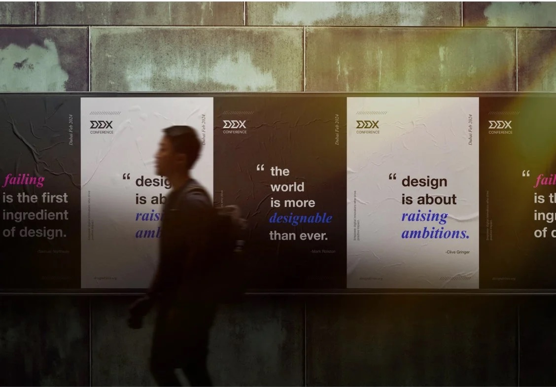 An attendee walking past the DDX quote wall